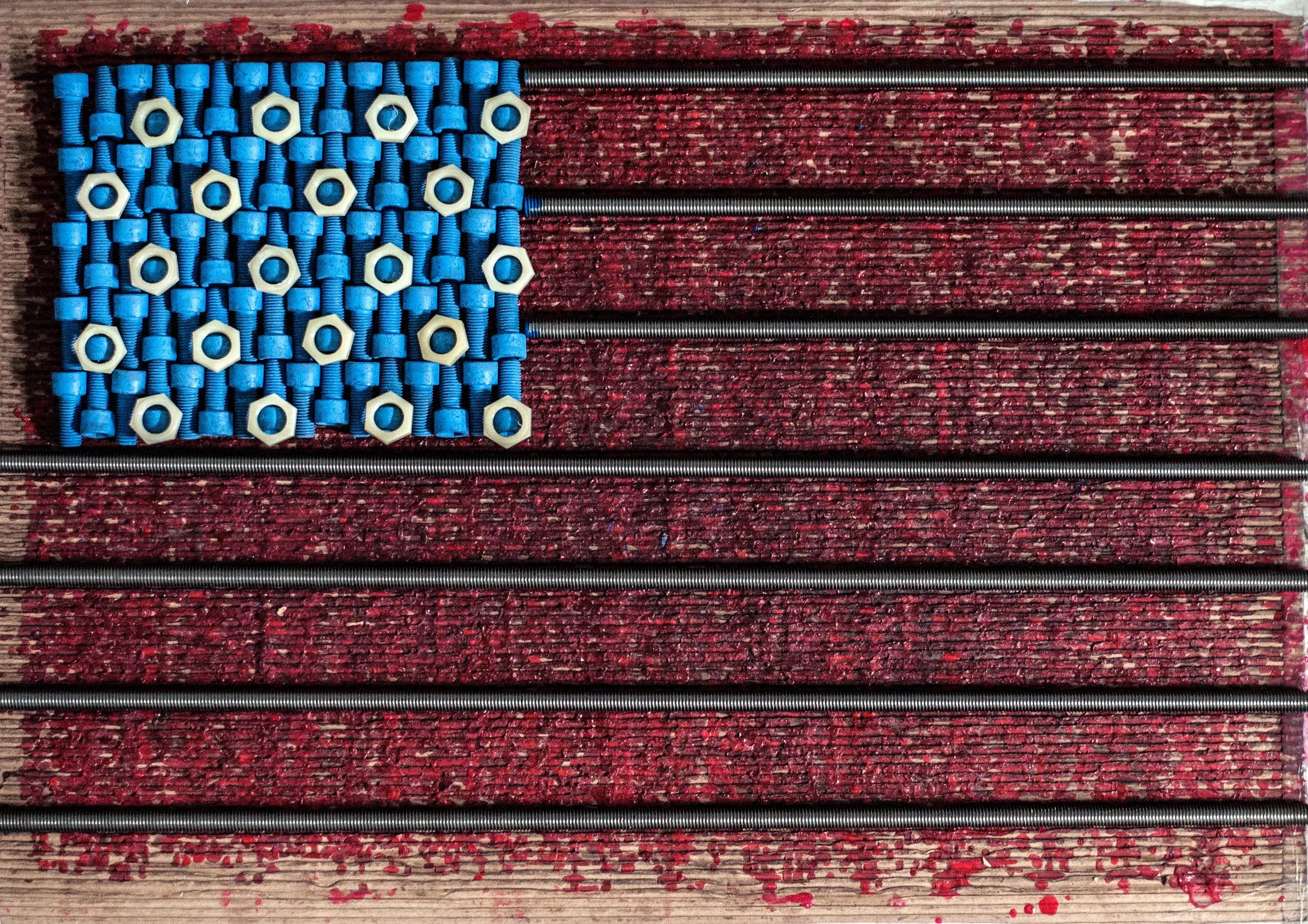 American flag made from blue socket head cap screws, hex nuts and threaded rod on red-painted wood