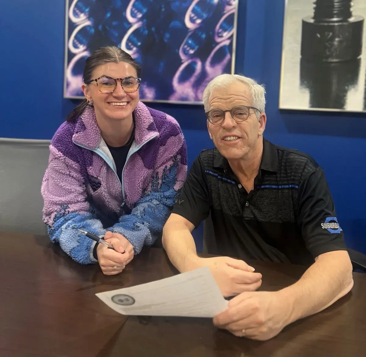 Two Suburban Bolt employees reviewing paperwork together