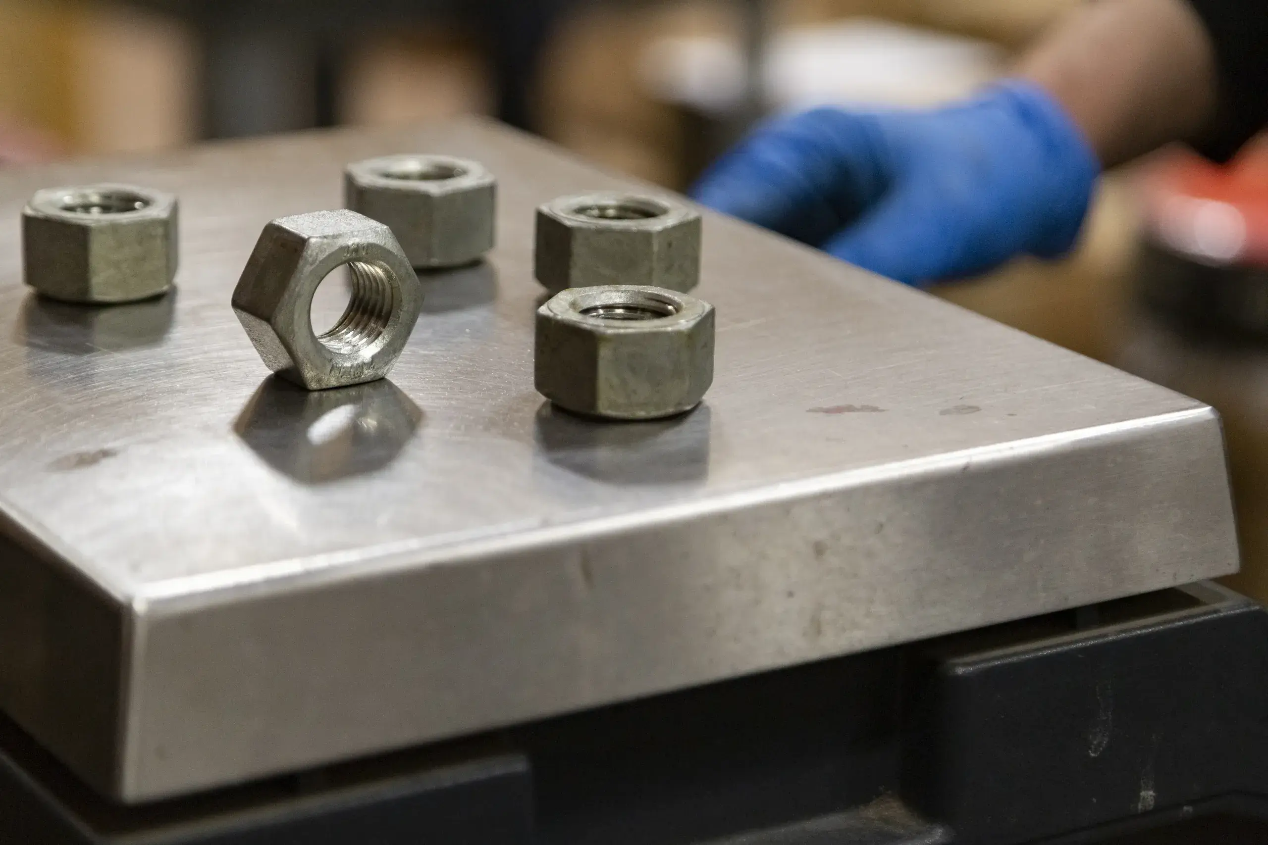 Close-up of heavy hex nuts on a steel plate